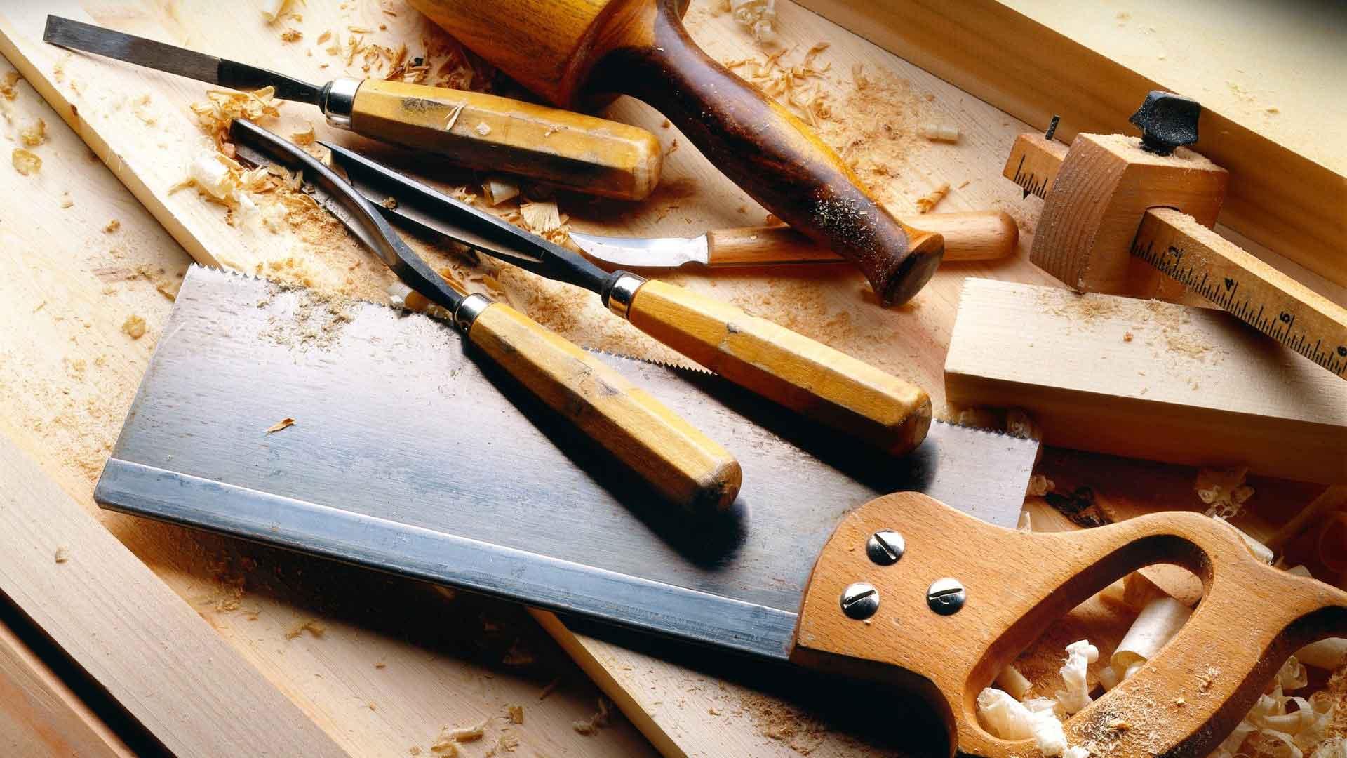Chisels, a marking gauge and a tenon saw resting on fresh timber shavings
