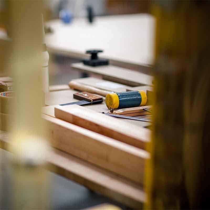 Hand tools and timber laid out on a workshop bench